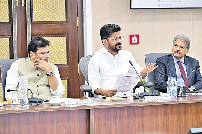 CM Revanth Reddy speaking in the meeting. Minister Sridhar Babu and Anand Mahindra in the picture